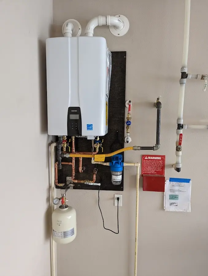 Professional plumber installing copper piping in a Veteran home